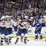 
              Gloves and sticks are tossed as the Colorado Avalanche celebrate winning the Stanley Cup against the Tampa Bay Lightning in Game 6 of the NHL hockey Stanley Cup Finals on Sunday, June 26, 2022, in Tampa, Fla. (AP Photo/Phelan Ebenhack)
            