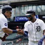 
              Detroit Tigers' Willi Castro, right, is greeted by Miguel Cabrera after scoring during the first inning of a baseball game against the Minnesota Twins, Thursday, June 2, 2022, in Detroit. (AP Photo/Carlos Osorio)
            
