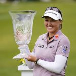 
              Brooke M. Henderson, of Canada, holds the trophy after winning the ShopRite LPGA Classic golf tournament, Sunday, June 12, 2022, in Galloway, N.J. (AP Photo/Matt Rourke)
            