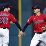 
              Cleveland Guardians' Andrés Giménez and Ernie Clement (28) celebrate the team's 8-4 win over the Oakland Athletics in a baseball game Thursday, June 9, 2022, in Cleveland. (AP Photo/Ron Schwane)
            