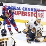 
              Edmonton Oil Kings' Jake Neighbours, second from left, watches as a goal is scored on Shawinigan Cataractes goaltender Charles-Antoine Lavallee during the first period of the Memorial Cup hockey game in Saint John, New Brunswick, Tuesday, June 21, 2022. (Darren Calabrese/The Canadian Press via AP)
            