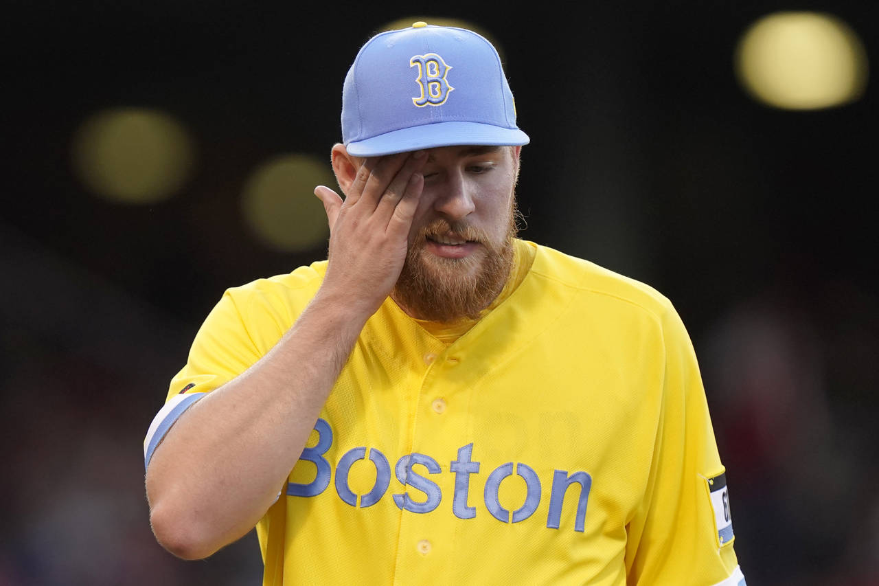 Boston Red Sox's Josh Winckowski wipes his face as he walks to the dugout after pitching against th...