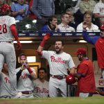 
              Philadelphia Phillies' Alec Bohm (28) is congratulated at the dugout by Kyle Schwarber after hitting a game-tying home run during the ninth inning of the team's baseball game against the Milwaukee Brewers on Tuesday, June 7, 2022, in Milwaukee. (AP Photo/Aaron Gash)
            