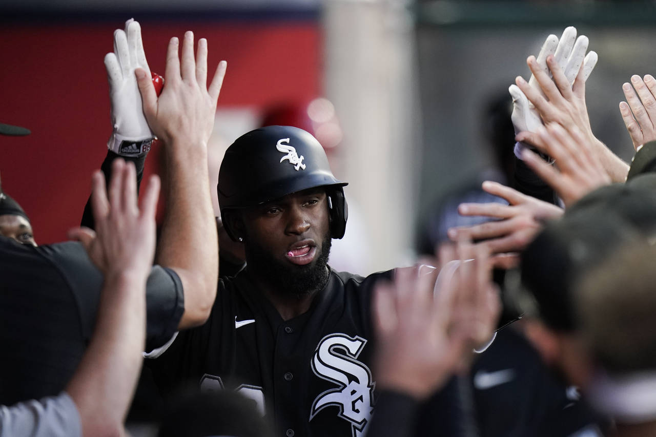 Chicago White Sox's Luis Robert is congratulated for his two-run home run during the fifth inning o...