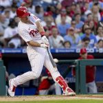 
              Philadelphia Phillies' J.T. Realmuto hits a two-run double during the first inning of the team's baseball game against the Los Angeles Angels, Saturday, June 4, 2022, in Philadelphia. (AP Photo/Laurence Kesterson)
            