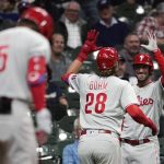 
              Philadelphia Phillies' Alec Bohm (28) is congratulated by Matt Vierling after hitting a game-tying home run against the Milwaukee Brewers during the ninth inning of a baseball game Tuesday, June 7, 2022, in Milwaukee. (AP Photo/Aaron Gash)
            