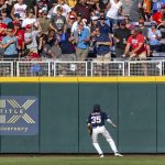 
              Mississippi left fielder Kevin Graham (35) watches the ball go over the wall for a home run by Arkansas' Chris Lanzilli (18) in the second inning during an NCAA College World Series baseball game Wednesday, June 22, 2022, in Omaha, Neb. (AP Photo/John Peterson)
            