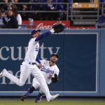 
              Los Angeles Dodgers center fielder Cody Bellinger, left, makes a catch on a ball hit by Cleveland Guardians' Owen Miller as right fielder Chris Taylor backs him up during the Ninth inning of a baseball game Friday, June 17, 2022, in Los Angeles. (AP Photo/Mark J. Terrill)
            