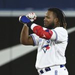 
              Toronto Blue Jays' Vladimir Guerrero Jr. gestures to the dugout after hitting a double against the Chicago White Sox in the sixth inning of a baseball game in Toronto, Thursday, June 2, 2022. (Jon Blacker/The Canadian Press via AP)
            