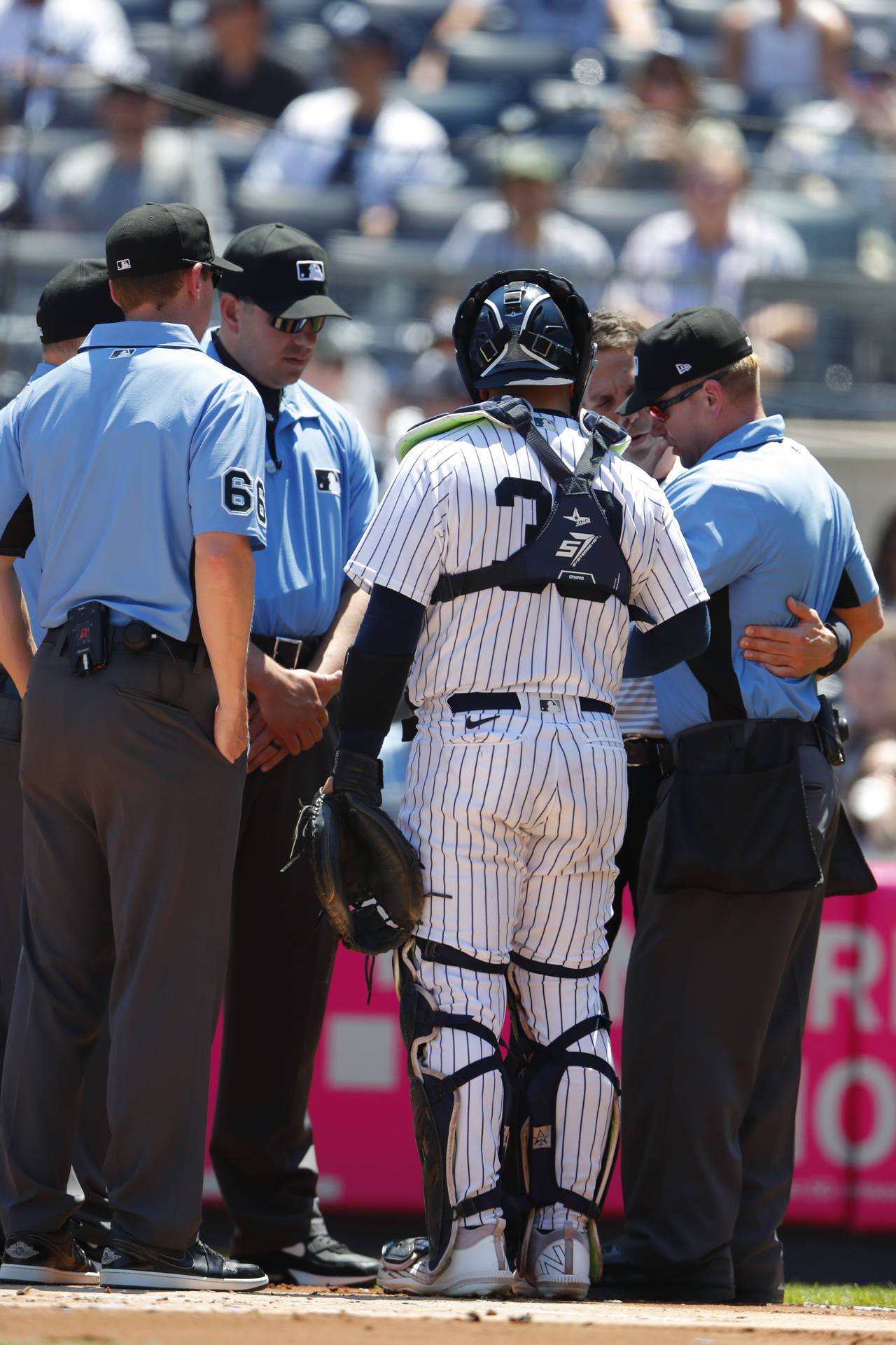 Umpire Mike Muchlinski, right, is attended to after being hit by a foul ball during the first innin...