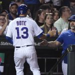 
              Chicago Cubs' David Bote (13) is greeted by manager David Ross after scoring against the Cincinnati Reds during the seventh inning of a baseball game in Chicago, Tuesday, June 28, 2022. (AP Photo/Matt Marton)
            
