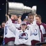 
              Colorado Avalanche defenseman Bowen Byram lifts the Stanley Cup during a rally outside the City/County Building for the NHL hockey champions after a parade through the streets of downtown Denver, Thursday, June 30, 2022. (AP Photo/David Zalubowski)
            