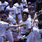 
              East Carolina's Bryson Worrell celebrates at the dugout after a home run against Texas during the fifth inning of an NCAA college super regional baseball game Friday, June 10, 2022, in Greenville, N.C. (AP Photo/Chris Carlson)
            