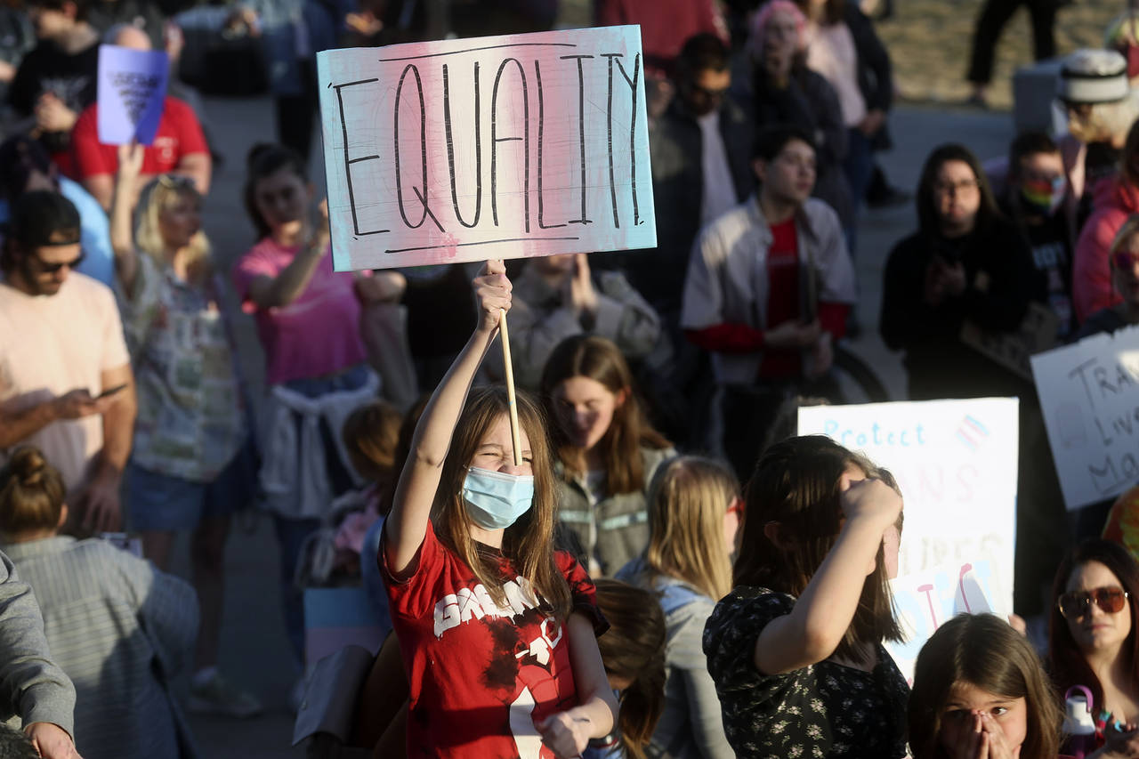 FILE - Ariel Peters holds an equality sign during a rally to support transgender youths outside of ...