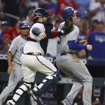 
              Atlanta Braves catcher Travis d'Arnaud, front left, tags out Los Angles Dodgers' Freddie Freeman, right, in a rundown between third and home on a fielder's choice during the sixth inning of a baseball game Sunday, June 26, 2022, in Atlanta. (Curtis Compton/Atlanta Journal-Constitution via AP)
            