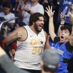 
              Fans react during an NBA basketball draft watch party in Orlando, Fla., after the Orlando Magic selected Duke's Paolo Banchero with the first pick in the draft Thursday, June 23, 2022. (Stephen M. Dowell/Orlando Sentinel via AP)
            