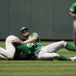 
              Oakland Athletics second baseman Jonah Bride, left, and right fielder Chad Pinder (10) collide while trying to field an RBI single hit by Kansas City Royals' Edward Olivares during the sixth inning of a baseball game Sunday, June 26, 2022, in Kansas City, Mo. (AP Photo/Charlie Riedel)
            