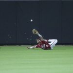 
              Arkansas outfielder Zack Gregory (3) slips while attempting to catch a fly ball during an NCAA college baseball tournament regional game against Oklahoma State in Stillwater, Okla., Sunday, June 5, 2022. (Ian Maule/Tulsa World via AP)
            