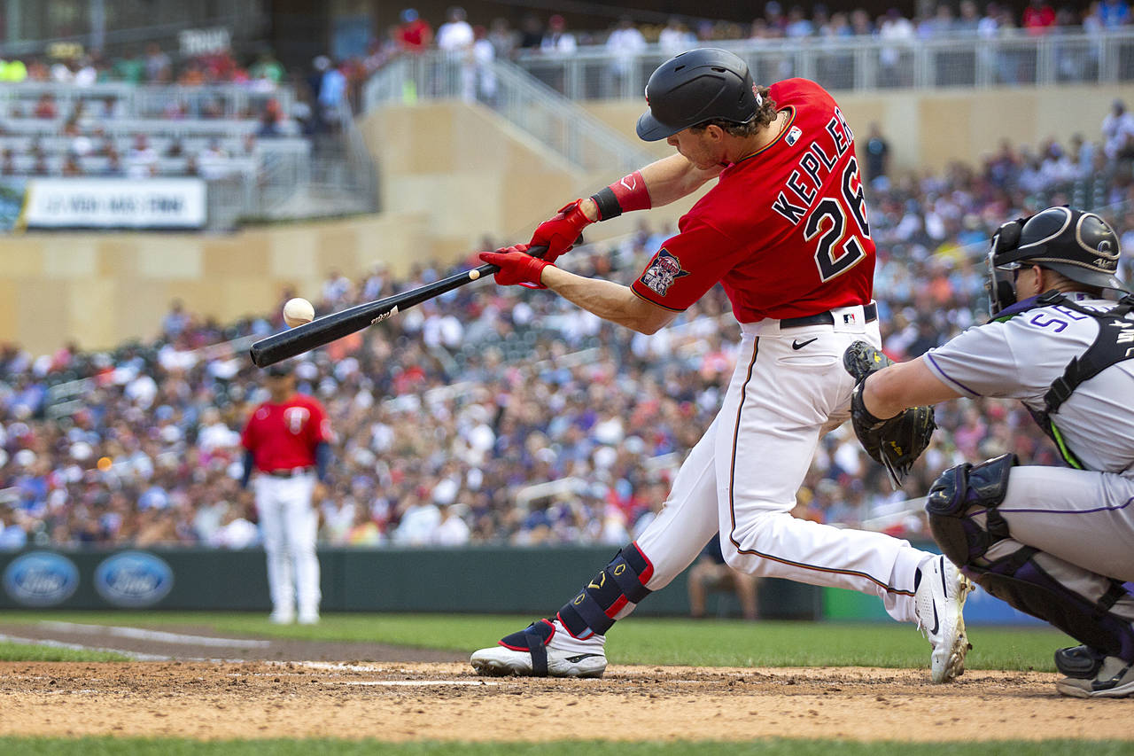 Minnesota Twins' Max Kepler hits an RBI-double against the Colorado Rockies in the seventh inning o...