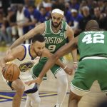 
              Golden State Warriors guard Stephen Curry (30) is defended by Boston Celtics center Al Horford (42) and guard Derrick White (9) during the first half of Game 1 of basketball's NBA Finals in San Francisco, Thursday, June 2, 2022. (AP Photo/Jed Jacobsohn)
            