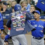 
              Toronto Blue Jays' Matt Chapman, center, is congratulated by manager Charlie Montoyo, right, after hitting a solo home run against the Milwaukee Brewers during the fifth inning of a baseball game Saturday, June 25, 2022, in Milwaukee. (AP Photo/Jon Durr)
            