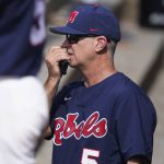 
              Mississippi coach Mike Bianco uses a communications device during the fourth inning of the team's NCAA college baseball tournament super regional game against Southern Mississippi, Saturday, June 11, 2022, in Hattiesburg, Miss. (AP Photo/Rogelio V. Solis)
            