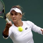 
              Ukraine's Lesia Tsurenko returns to Britain's Jodie Burrage during a women's singles first round match on day one of the Wimbledon tennis championships in London, Monday, June 27, 2022. (Steve Paston/PA via AP)
            