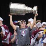 
              Colorado Avalanche general manager Joe Sakic lifts the Stanley Cup during a rally outside the City/County Building for the NHL hockey champions after a parade through the streets of downtown Denver, Thursday, June 30, 2022. (AP Photo/David Zalubowski)
            