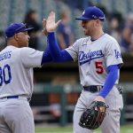 
              Los Angeles Dodgers manager Dave Roberts (30) and first baseman Freddie Freeman celebrate the team's 11-9 win over the Chicago White Sox in a baseball game Thursday, June 9, 2022, in Chicago. (AP Photo/Charles Rex Arbogast)
            
