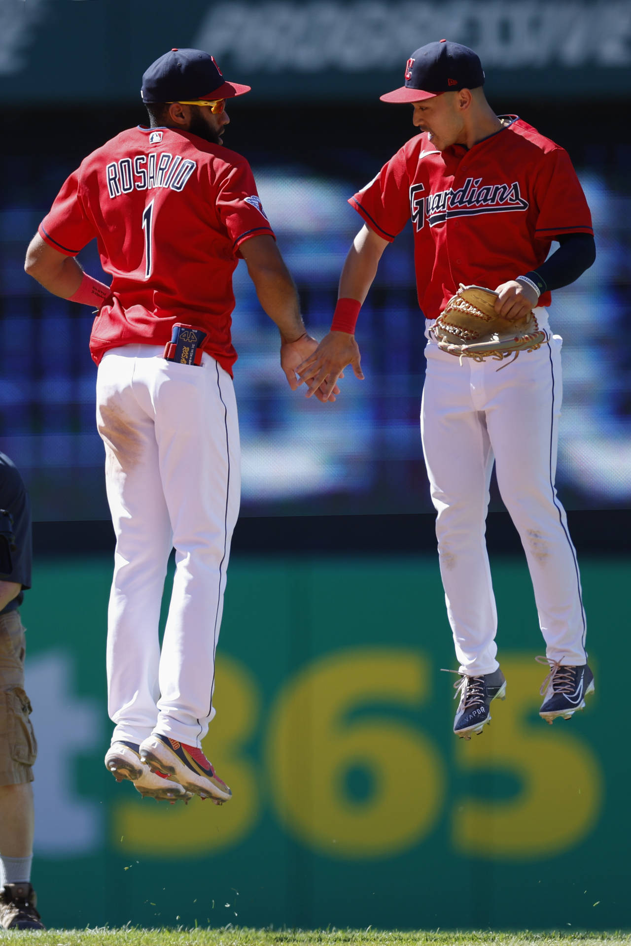 Cleveland Guardians shortstop Amed Rosario and left fielder Steven Kwan celebrate a win against the...