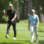 
              Dustin Johnson of the United States, left, and Sam Horsfield of Britain walk on the course during the final round of the inaugural LIV Golf Invitational at the Centurion Club in St. Albans, England, Saturday, June 11, 2022. (AP Photo/Alastair Grant)
            