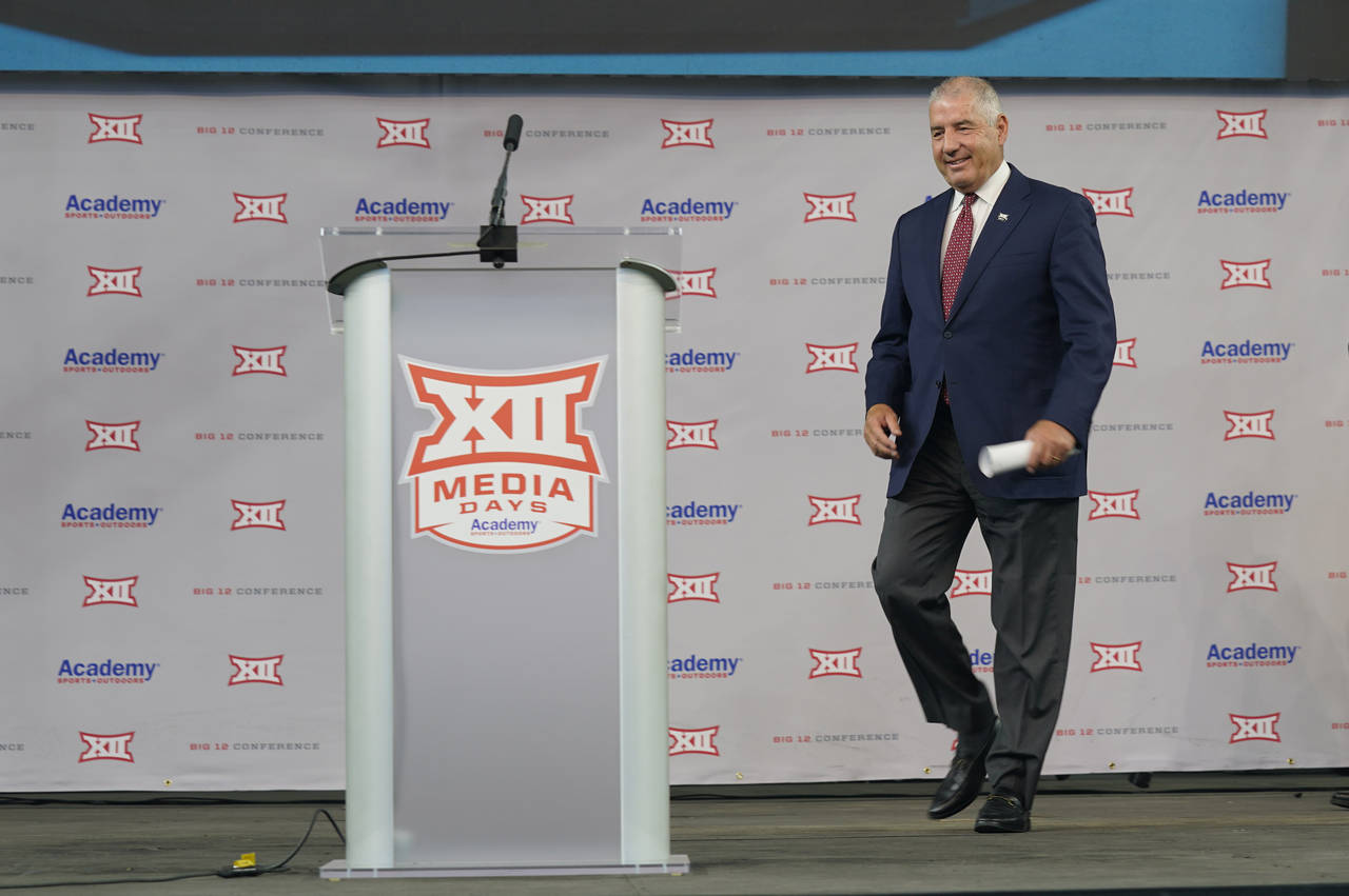 FILE - Big 12 Commissioner Bob Bowlsby walks to the podium to speak during the Big 12 football medi...