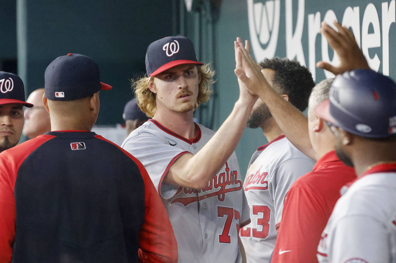 Washington Nationals starting pitcher Jackson Tetreault (72) is congratulated in the dugout after b...