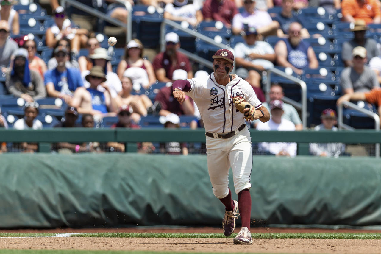 Texas A&M third baseman Trevor Werner throws to first for an out against Texas in the first inning ...