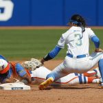 
              Florida outfielder Cheyenne Lindsey (2) is slides in safe at second base before UCLA infielder Briana Perez (3) can make the tag during the fifth inning of an NCAA softball Women's College World Series game on Sunday, June 5, 2022, in Oklahoma City. (AP Photo/Alonzo Adams)
            