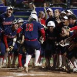 
              Arizona catcher Sharlize Palacios (18) is met at home plate after a home run against Oklahoma State during the fifth inning of an NCAA softball Women's College World Series game Thursday, June 2, 2022, in Oklahoma City. (AP Photo/Alonzo Adams)
            
