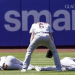 
              Houston Astros' Jake Meyers (6) watches as Jeremy Pena, left, and Yordan Alvarez fall to the ground after colliding catching a fly ball by New York Mets' Dominic Smith during the eighth inning of a baseball game, Wednesday, June 29, 2022, in New York. (AP Photo/Mary Altaffer)
            
