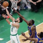 
              Boston Celtics forward Jayson Tatum (0) puts up a shot against Golden State Warriors forward Draymond Green (23) during the first quarter of Game 6 of basketball's NBA Finals, Thursday, June 16, 2022, in Boston. (AP Photo/Michael Dwyer)
            