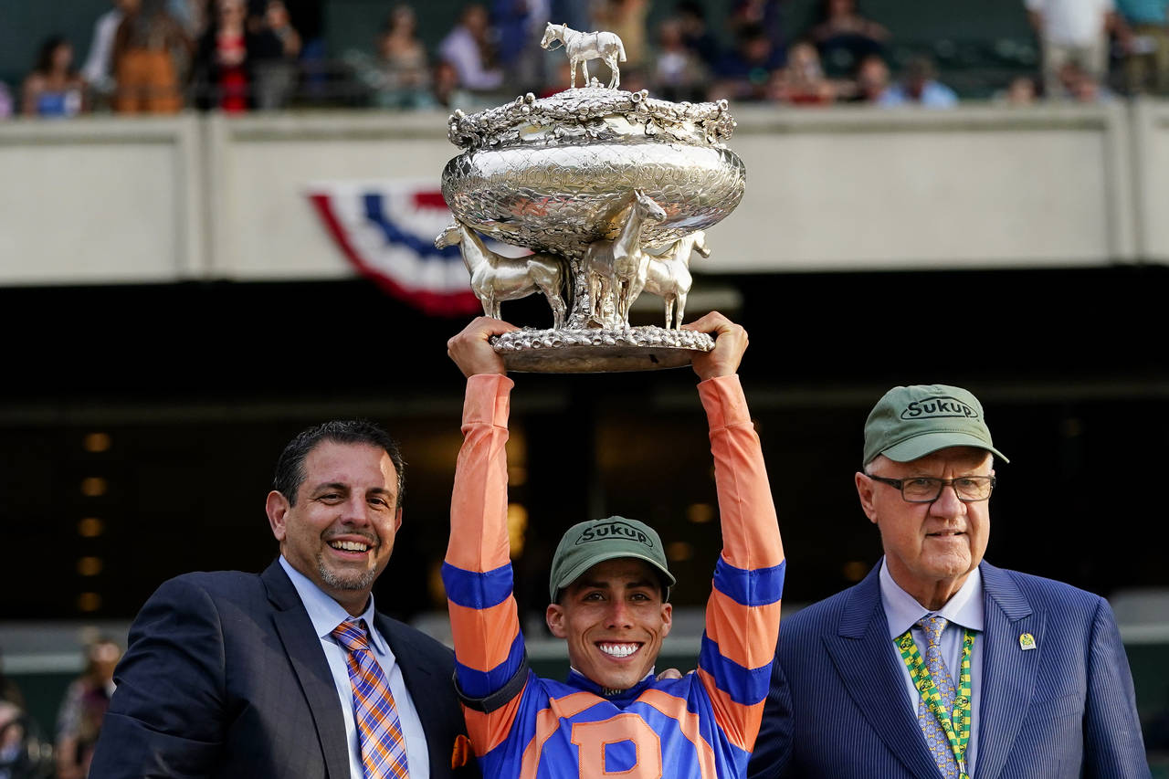 Jockey Irad Ortiz Jr. holds the August Belmont Memorial Cup after Mo Donegal won the Belmont Stakes...
