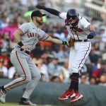 
              Atlanta Braves shortstop Dansby Swanson is tagged out on a run down by San Francisco Giants third baseman Evan Longoria on a fielders choice by Austin Riley during the first inning of a baseball game on Monday, June 20, 2022, in Atlanta. (Curtis Compton/Atlanta Journal-Constitution via AP)
            
