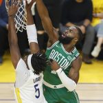 
              Boston Celtics guard Jaylen Brown, top, defends against a shot by Golden State Warriors center Kevon Looney (5) during the first half of Game 1 of basketball's NBA Finals in San Francisco, Thursday, June 2, 2022. (AP Photo/John Hefti)
            
