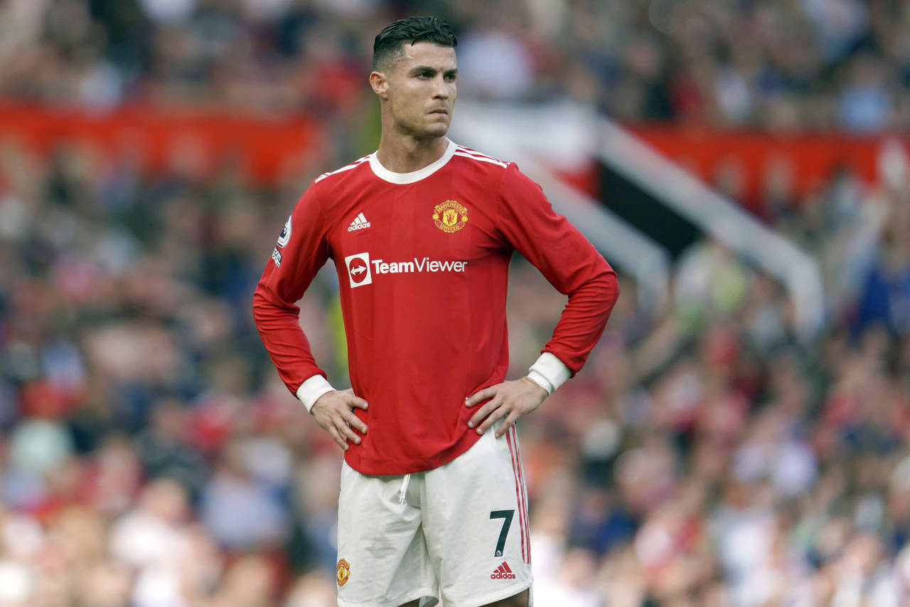 FILE- Manchester United's Cristiano Ronaldo stands on the pitch during the English Premier League s...