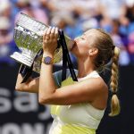 
              Czech Republic's Petra Kvitova celebrates with the trophy after winning the women's singles final match against Latvia's Jelena Ostapenko on day eight of the Rothesay International Eastbourne at Devonshire Park, Eastbourne, Britain, Saturday June 25, 2022. (Adam Davy/PA via AP)
            