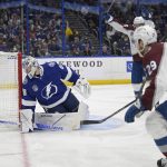 
              Colorado Avalanche center Nathan MacKinnon (29) shoots the puck past Tampa Bay Lightning goaltender Andrei Vasilevskiy (88) for a goal during the second period of Game 6 of the NHL hockey Stanley Cup Finals on Sunday, June 26, 2022, in Tampa, Fla. (AP Photo/Phelan Ebenhack)
            