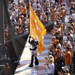 
              Smokey, the Tennessee mascot, runs on top of the dugout after Tennessee beat Notre Dame 12-4 in an NCAA college baseball super regional game Saturday, June 11, 2022, in Knoxville, Tenn. The teams are tied in the series 1-1. (AP Photo/Randy Sartin)
            