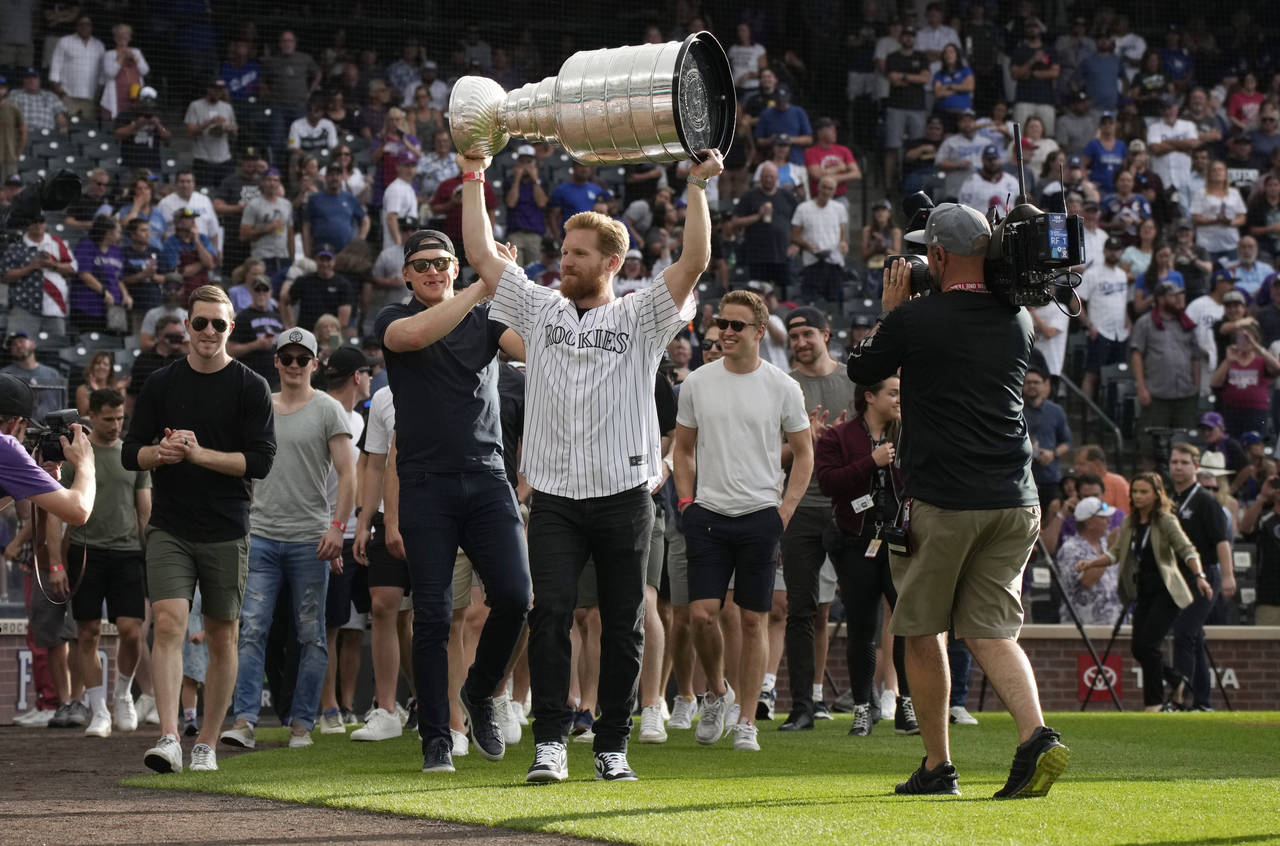 Colorado Avalanche captain Gabriel Landeskog holds up the Stanley Cup as the NHL hockey team was ho...