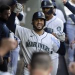 
              Seattle Mariners' Eugenio Suarez celebrates after hitting a two-run home run off Minnesota Twins starting pitcher Joe Ryan during the fourth inning of a baseball game Tuesday, June 14, 2022, in Seattle. (AP Photo/Stephen Brashear)
            