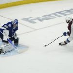 
              Colorado Avalanche center Nazem Kadri (91) shoots the puck past Tampa Bay Lightning goaltender Andrei Vasilevskiy (88) for a goal during overtime of Game 4 of the NHL hockey Stanley Cup Finals on Wednesday, June 22, 2022, in Tampa, Fla. (AP Photo/John Bazemore)
            