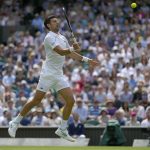 
              Serbia's Novak Djokovic returns the ball to Australia's Thanasi Kokkinakis during their singles tennis match on day three of the Wimbledon tennis championships in London, Wednesday, June 29, 2022. (AP Photo/Alastair Grant)
            