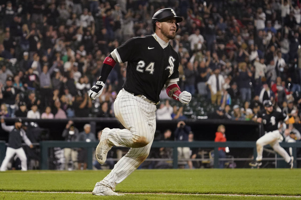 Chicago White Sox's Yasmani Grandal runs after hitting a two-run double during the eighth inning of...